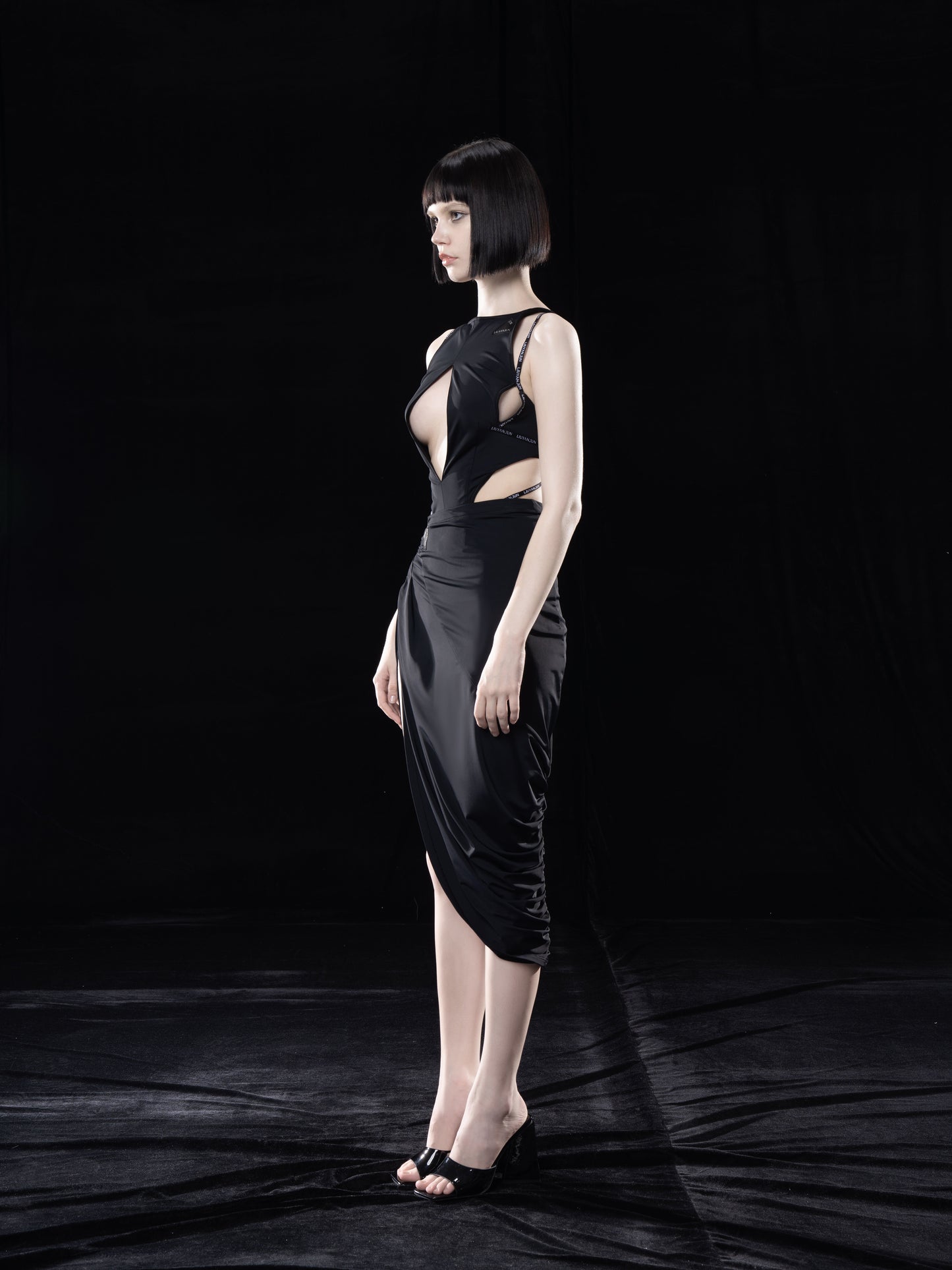 BLACK ASYMMETRIC WRAP SKIRT WITH CUT-OUTS
