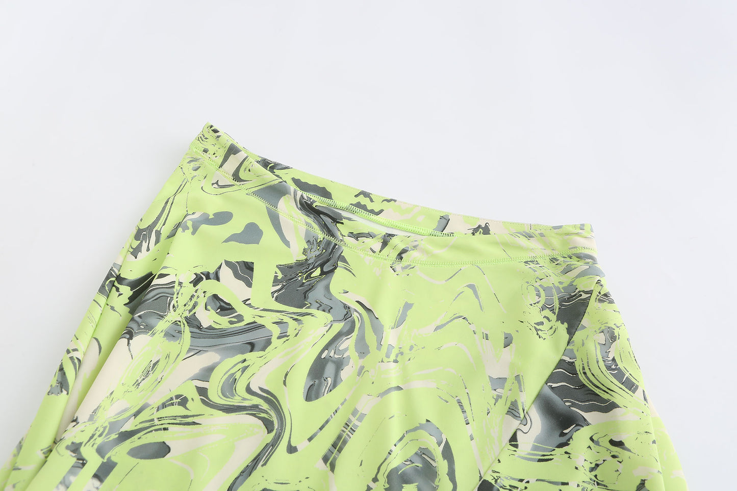 NEON GREEN ASYMMETRIC WRAP. SKIRT WITH. CUT-OUTS