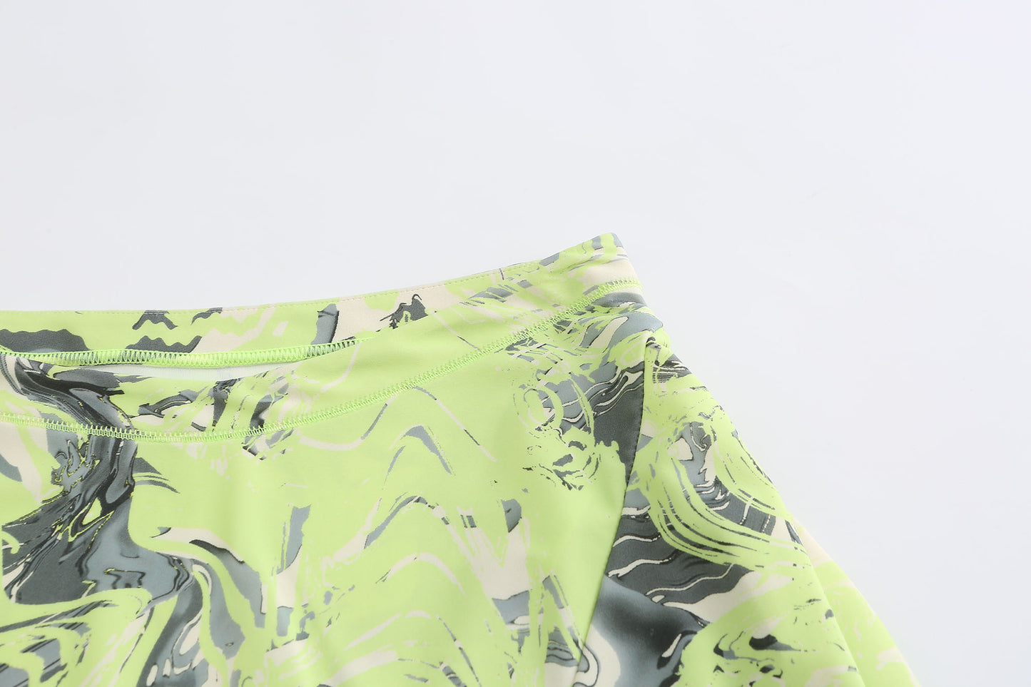 NEON GREEN ASYMMETRIC WRAP. SKIRT WITH. CUT-OUTS