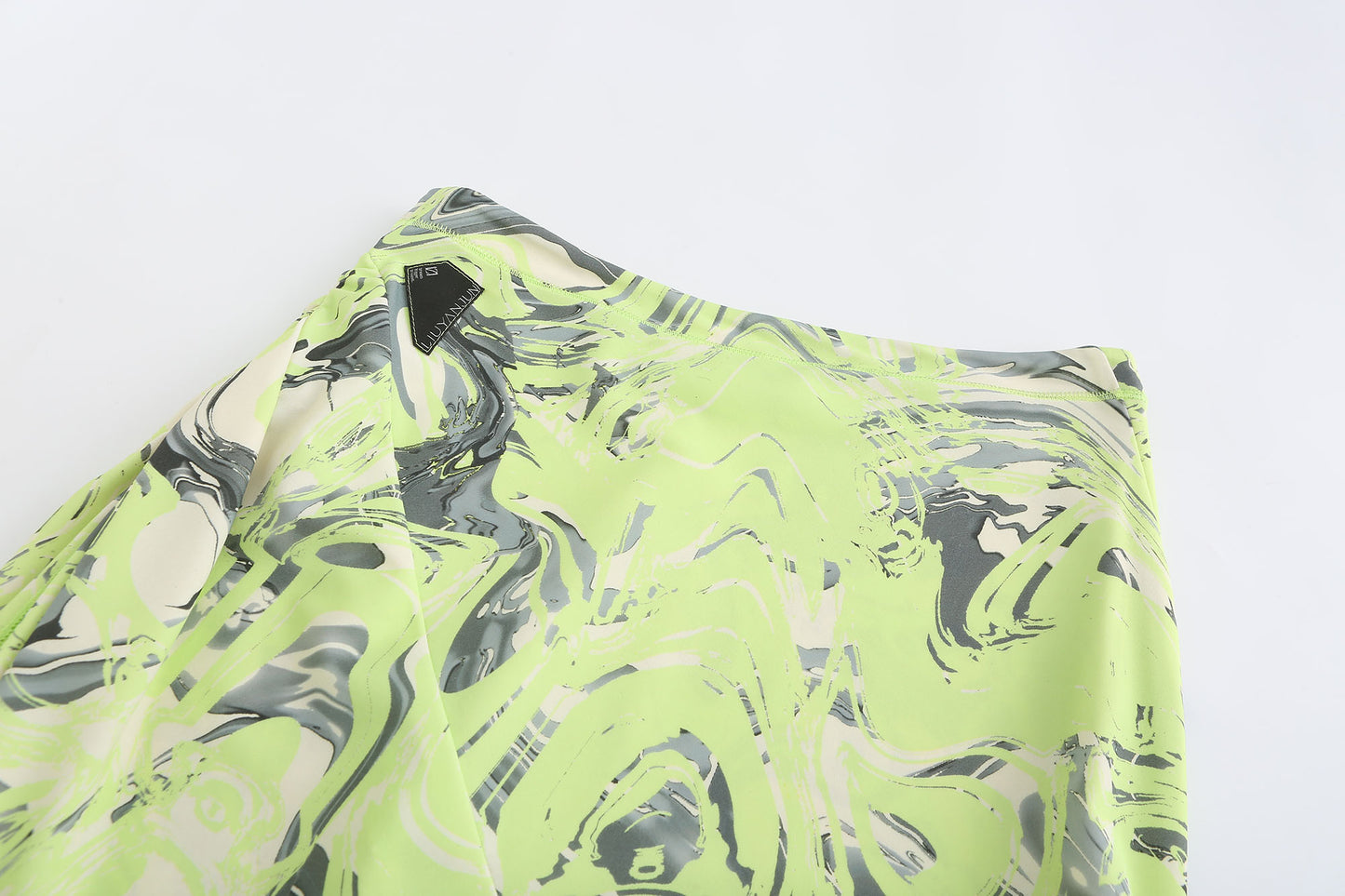NEON GREEN ASYMMETRIC WRAP. SKIRT WITH. CUT-OUTS